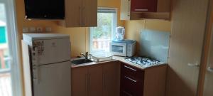 a small kitchen with a sink and a refrigerator at Lou Rigaou in Aups