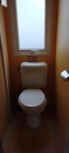 a small bathroom with a toilet with a window at Lou Rigaou in Aups