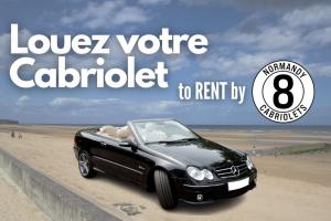 a black convertible car parked on a beach at COSY HOUSE quite house in quite place in Bayeux