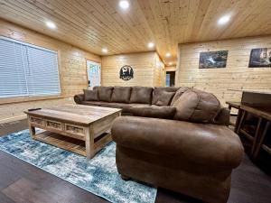 a living room with a couch and a coffee table at The Brick House: Brand NEW! 3 Bedroom Home with private driveway in Pigeon Forge