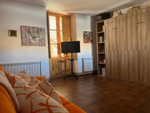a living room with a couch and a tv at El Cantón Casa rural in Castril