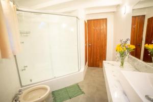 a bathroom with a shower and a toilet and a sink at Casa das Pedras in Monte Verde +14 photos