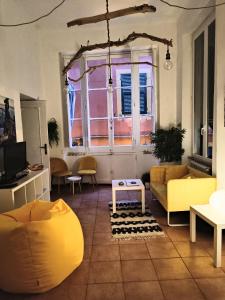 a living room with a yellow couch and a window at Il Balconcino sul carugio in Monterosso al Mare