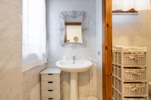 a bathroom with a sink and a mirror at Villa Lilla in Villasimius