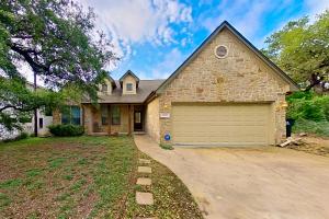 a brick house with a garage in a yard at Tucumcari Treat in Austin