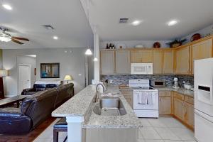 a kitchen with a sink and a living room at Tucumcari Treat in Austin