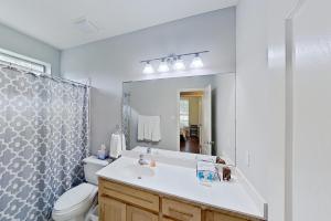 a bathroom with a sink and a toilet and a mirror at Tucumcari Treat in Austin +9 photos