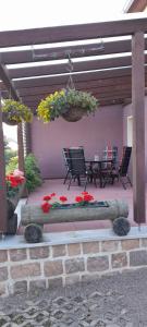 a patio with chairs and a hanging basket of flowers at Kockscher Hof in Mittweida