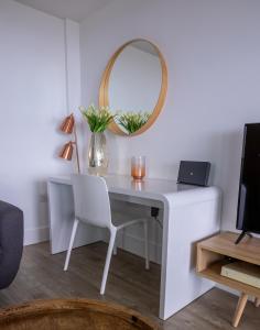 a white desk with a mirror and a chair at Seaview West Coast in Bournemouth