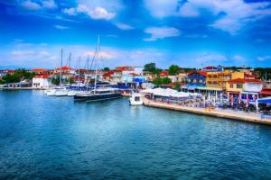 a group of boats docked at a marina with buildings at Christina Apartments in Keramoti