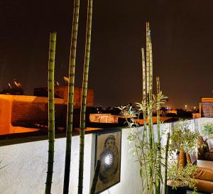 a view of a city at night with palm trees at DAR Riad Jomana in Marrakech