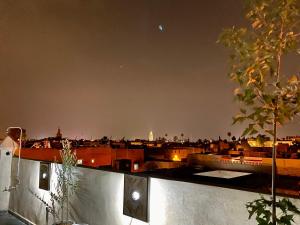a view of a city skyline at night at DAR Riad Jomana in Marrakech