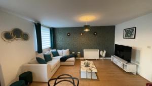 a living room with a couch and a tv at Waterfront town centre ipswich apartment in Ipswich