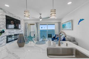 a kitchen with a sink and a living room at Sunset Paradise - Find yourself in Tampa in Tampa