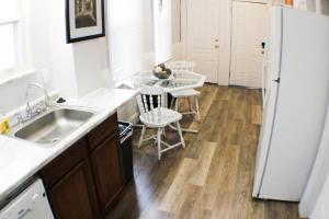 a kitchen with a sink and a white refrigerator at 2 BR - Off Street Parking - Amazing View Nearby in Pittsburgh