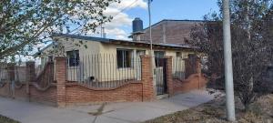 an old brick house with a fence around it at Cuarta División Apartments in Malargüe