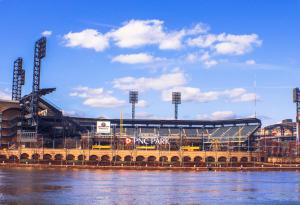 a view of a baseball stadium next to the water at 2BR - Parking - 5 Min to North Shore! in Pittsburgh