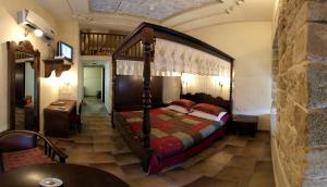 
a bedroom with a bed and a dresser at Akkotel-Boutique hotel in Acre
