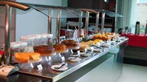 a buffet line with cupcakes and muffins on display at Gênova Palace Hotel in Acailandia
