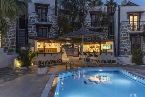 a swimming pool in front of a house at Bodrum Vera Hotel in Bodrum City