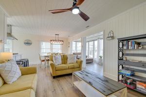 a living room with a couch and a ceiling fan at Holden Beach Home on Intracoastal Waterway Canal! in Holden Beach