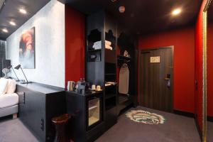 a room with red and black walls and a closet at Radisson Sonya Hotel in Saint Petersburg
