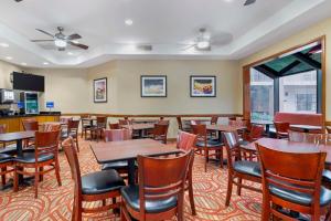 a dining room with wooden tables and chairs at Best Western Mcallen Medical Center in McAllen
