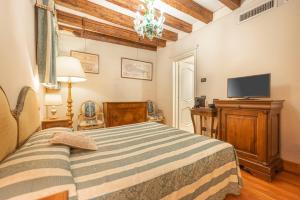 a bedroom with a bed and a flat screen tv at Cà Valeri in Venice