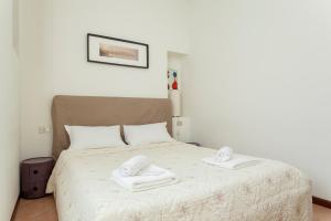 Łóżko lub łóżka w pokoju w obiekcie Exquisite Stay Vannucci- Porta Romana