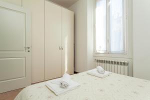 Łóżko lub łóżka w pokoju w obiekcie Exquisite Stay Vannucci- Porta Romana