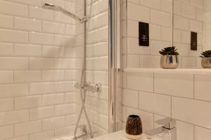 a bathroom with a shower and a sink at New London Life Executive Apartments in Chelmsford