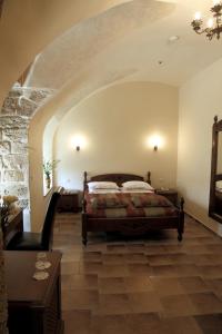 a bedroom with a bed in the middle of a room at Akkotel-Boutique hotel in &lsquo;Akko