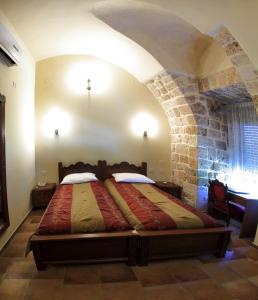 
a bed room with two beds and a fireplace at Akkotel-Boutique hotel in Acre
