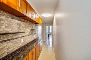 a hallway with wooden cabinets and a brick wall at The Philly place to stay! 2BD apartment steps from the Convention Center in Philadelphia
