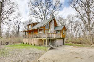 een houten huis met een veranda en een balkon bij Spacious Buckeye Lake Home with Hot Tub and Fire Pit! in Buckeye Lake