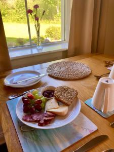a table with a plate of food on a table at Rugged Glen Accommodation in Glengarriff