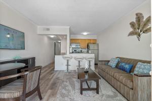 uma sala de estar com um sofá e uma cozinha em Wake up to Ocean Views from your private balcony em Tampa