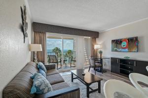 a living room with a couch and a table at Wake up to Ocean Views from your private balcony in Tampa