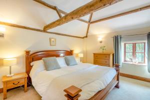 a bedroom with a large bed and a window at The Hayloft in Ashill