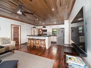 a kitchen and living room with a ceiling fan at Three by the Sea in San Pedro