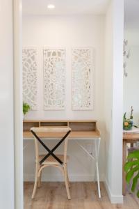 a desk with a chair in a room with white walls at Grace Road Getaway in Tauranga
