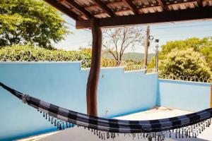 a hammock hanging from a roof over a pool at Aconchego e tranquilidade 3 in Bonito