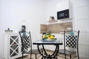 a kitchen with a table with a bowl of fruit on it at B&B DieMme Amalfi Coast in Vietri sul Mare