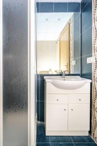 a bathroom with a white sink and a mirror at Ideal familias zona infantil y vistas a pistas in Candanchú