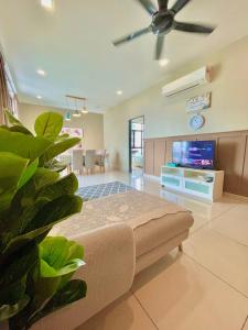 a living room with a couch and a ceiling fan at Citywoods 2B2BR - JB Town near HSA, CIQ, Mall - WiFi in Johor Bahru