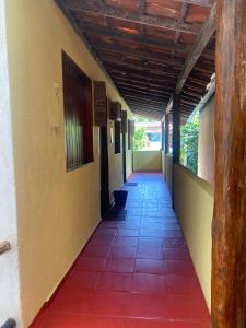 an empty hallway of a building with a tile floor at Pousada Pituba in Itacaré