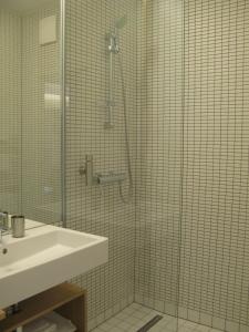 a bathroom with a shower and a sink at Key Inn Appart Hotel Parc de Merl in Luxembourg