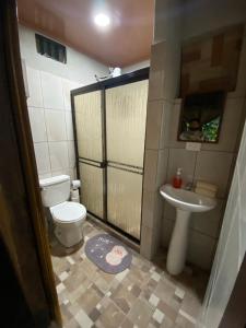 a small bathroom with a toilet and a sink at Villas Cacao in Fortuna