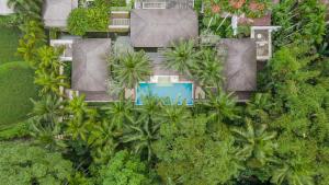 an overhead view of a house with palm trees at Uma Giri Villas Ubud by Pramana Villas in Ubud