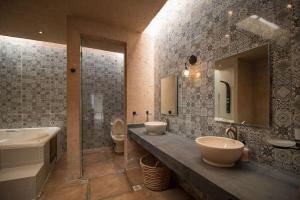 łazienka z 2 umywalkami, wanną i toaletą w obiekcie Casa de campo nubes cerca de Morelia w mieście Patámbaro